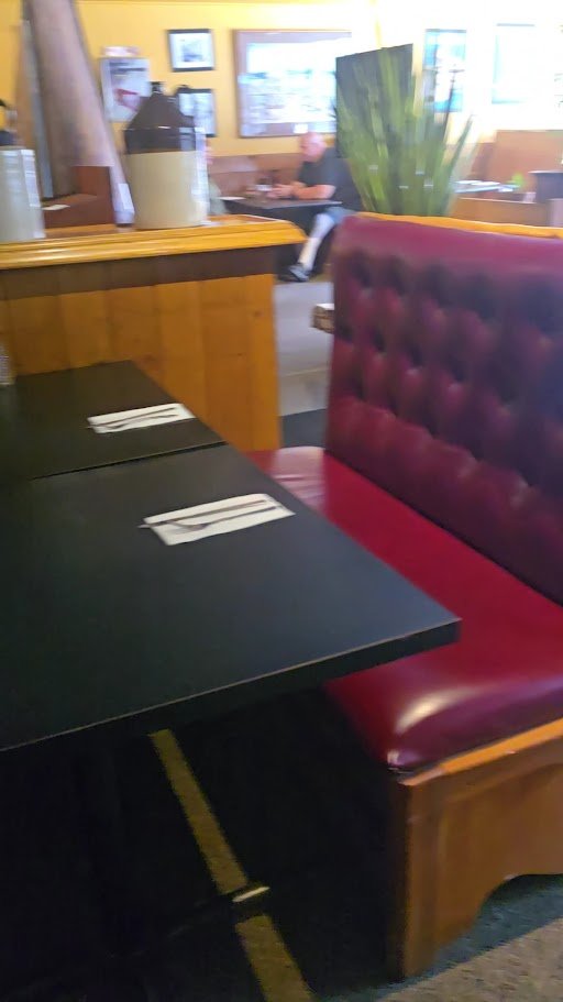 Warm interior with bar seating and pendant lights.
